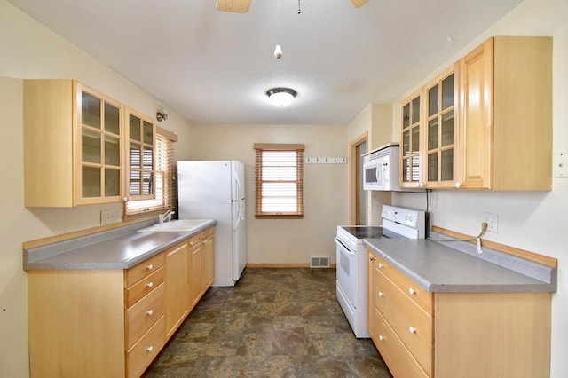 kitchen with sink, light brown cabinetry, ceiling fan, a textured ceiling, and white appliances