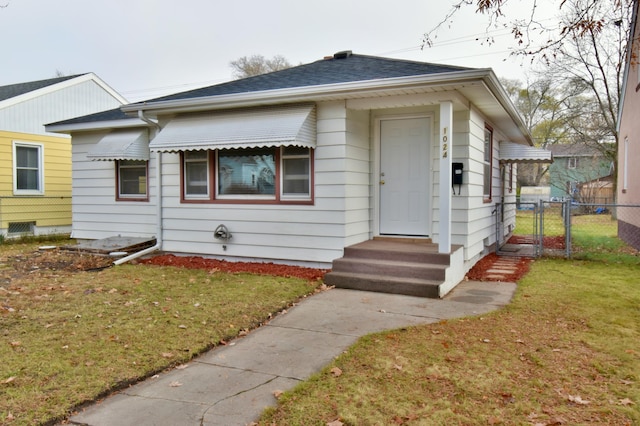 bungalow-style house featuring a front yard