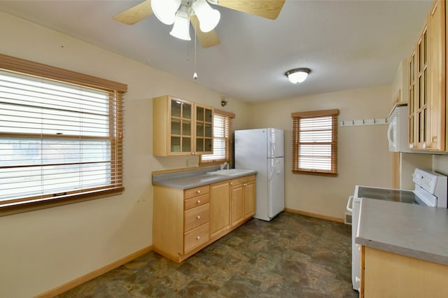 kitchen with white appliances, ceiling fan, light brown cabinetry, and sink