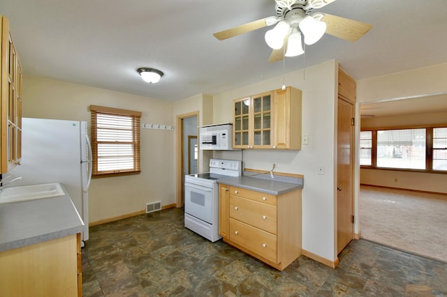 kitchen with dark colored carpet, sink, light brown cabinetry, ceiling fan, and white appliances