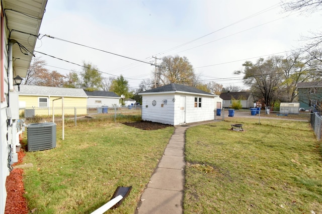 view of yard featuring central AC unit and a storage unit