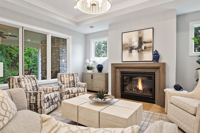 living area with ornamental molding and light hardwood / wood-style flooring