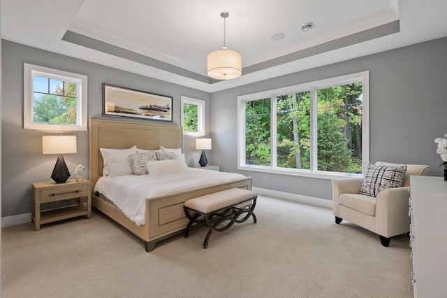 bedroom with a raised ceiling, ornamental molding, and light colored carpet