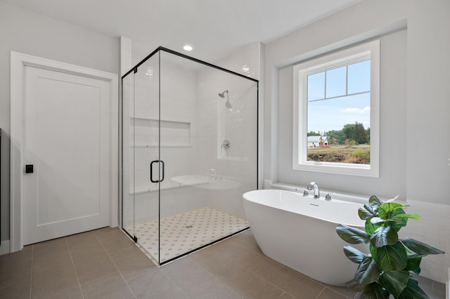 bathroom with tile patterned floors and plus walk in shower