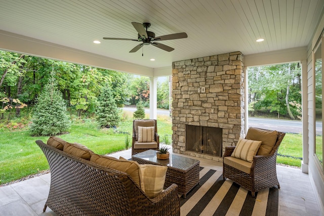 view of patio / terrace featuring an outdoor living space with a fireplace and ceiling fan