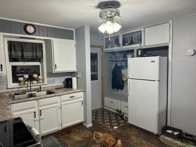 kitchen featuring sink, white cabinetry, ceiling fan, stove, and white refrigerator