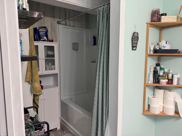 bathroom with hardwood / wood-style floors and shower / bath combo