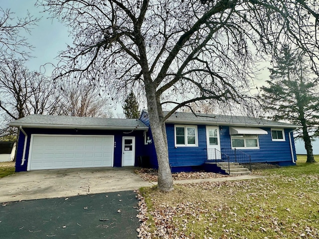 ranch-style home with driveway and an attached garage