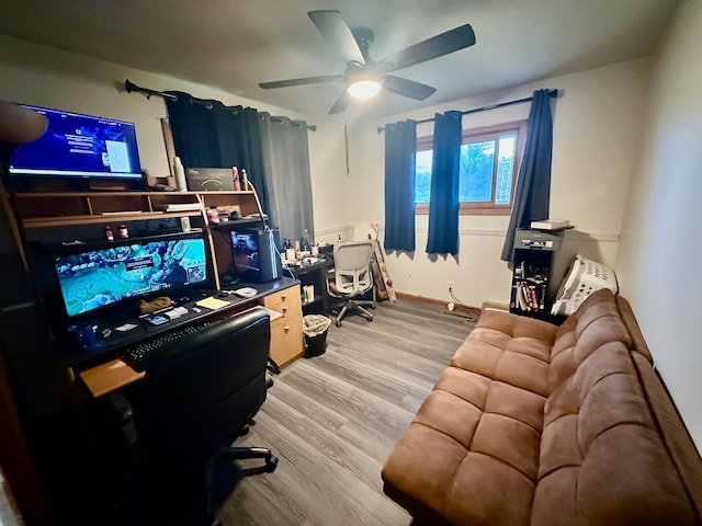 office space with ceiling fan, baseboards, and wood finished floors