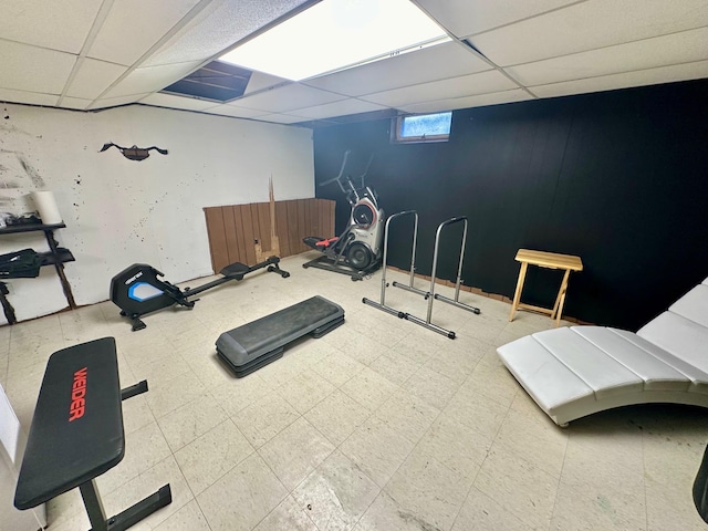 workout room with a drop ceiling and tile patterned floors