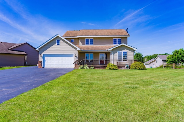 view of front of house with a front lawn and a garage