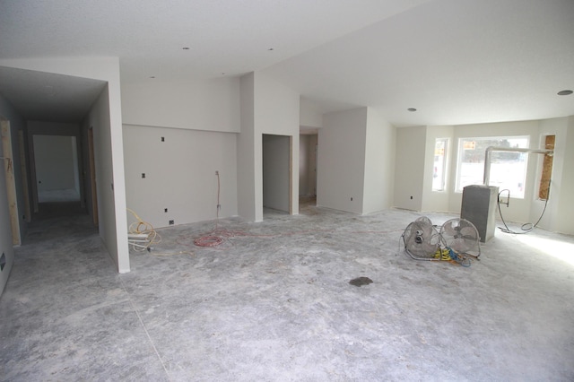 unfurnished living room featuring lofted ceiling