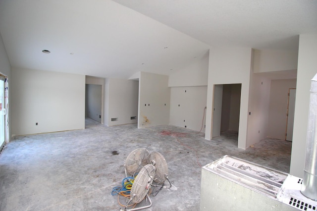 unfurnished living room featuring high vaulted ceiling