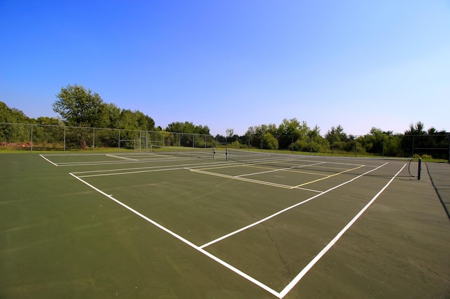 view of tennis court featuring basketball hoop