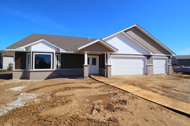 1067 241st Ln NE, East Bethel, MN 55005 - view of front facade featuring brick siding, an attached garage, and a shingled roof