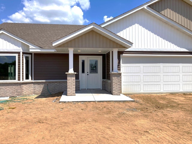 1067 241st Ln NE, East Bethel, MN 55005 - view of front of home with a shingled roof, an attached garage, covered porch, and brick siding