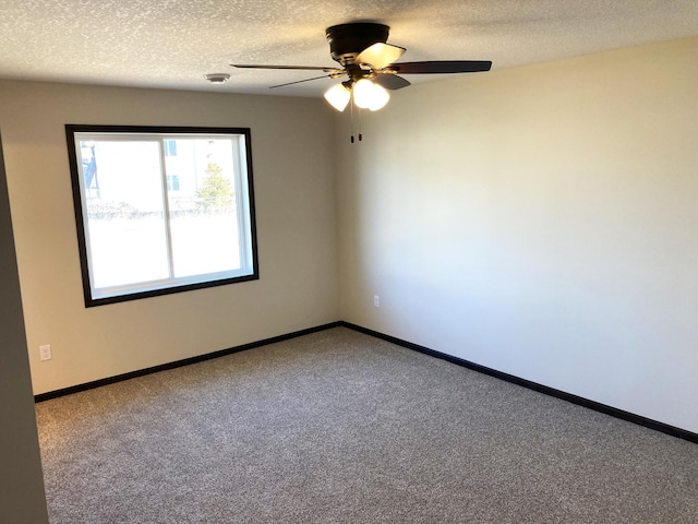 1067 241st Ln NE, East Bethel, MN 55005 - carpeted empty room featuring a ceiling fan, a textured ceiling, and baseboards