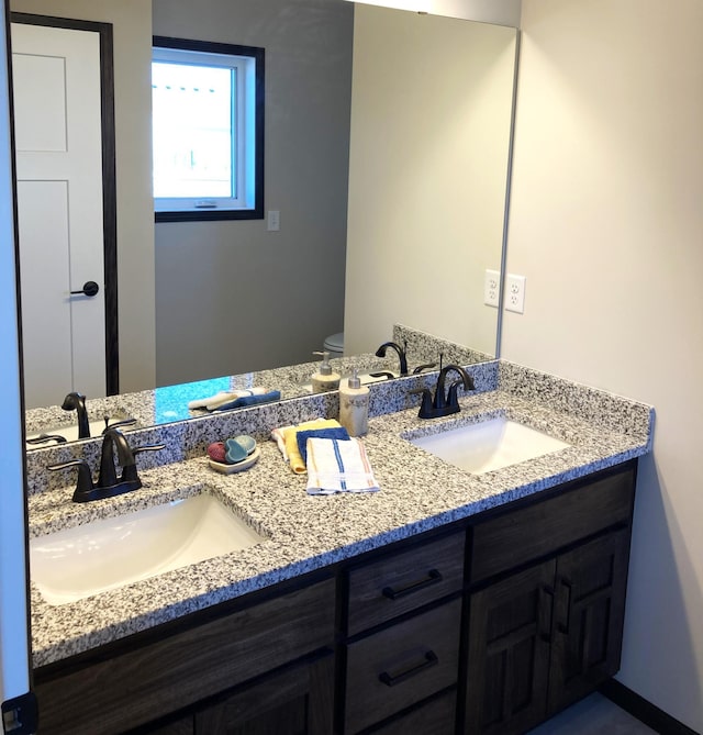 1067 241st Ln NE, East Bethel, MN 55005 - bathroom featuring double vanity and toilet