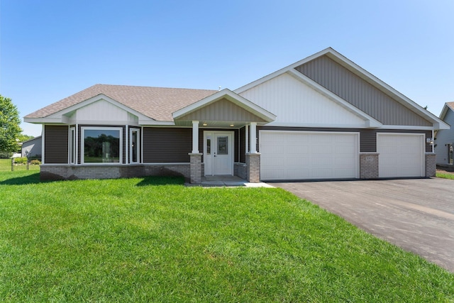 1067 241st Ln NE, East Bethel, MN 55005 - view of front facade with brick siding, driveway, an attached garage, a front lawn, and a shingled roof