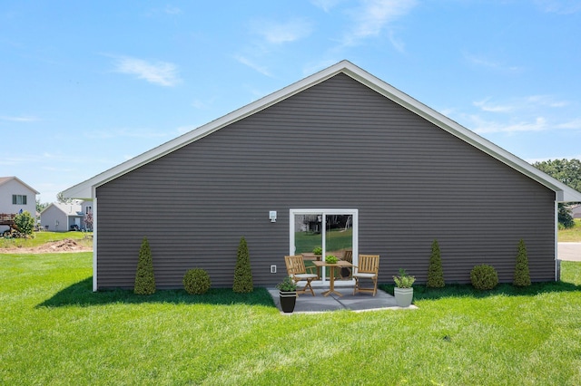 1067 241st Ln NE, East Bethel, MN 55005 - back of property featuring a lawn and a patio area