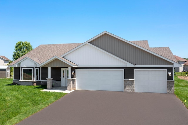 1067 241st Ln NE, East Bethel, MN 55005 - craftsman house with a garage, driveway, a shingled roof, a front yard, and brick siding