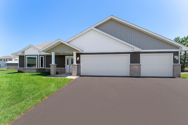 1067 241st Ln NE, East Bethel, MN 55005 - craftsman inspired home featuring brick siding, a garage, asphalt driveway, and a front lawn