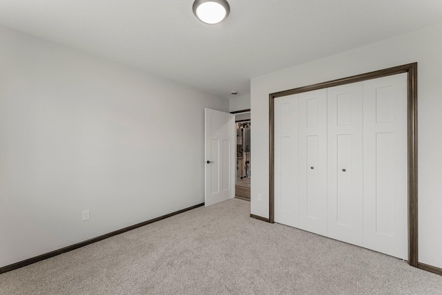 1067 241st Ln NE, East Bethel, MN 55005 - unfurnished bedroom featuring light carpet and a closet