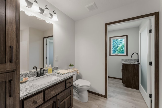 1067 241st Ln NE, East Bethel, MN 55005 - bathroom featuring vanity and wood finished floors