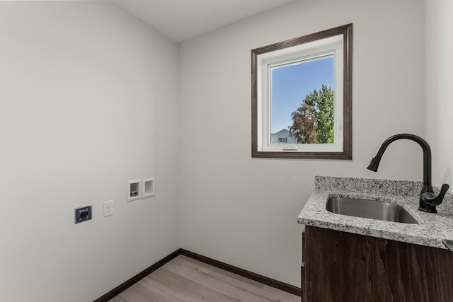 1067 241st Ln NE, East Bethel, MN 55005 - laundry room featuring hookup for an electric dryer, light wood finished floors, cabinet space, and hookup for a washing machine