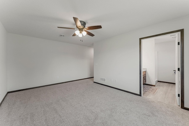 1067 241st Ln NE, East Bethel, MN 55005 - spare room with light colored carpet, a ceiling fan, and a smoke detector
