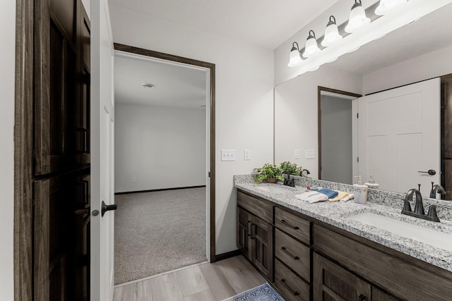 1067 241st Ln NE, East Bethel, MN 55005 - full bath featuring double vanity and wood finished floors