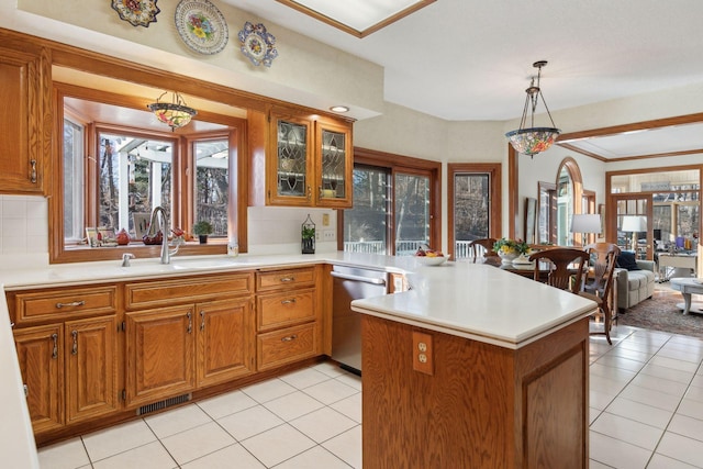 kitchen with decorative light fixtures, backsplash, dishwasher, kitchen peninsula, and sink