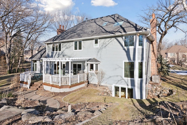 back of house featuring central AC unit and a pergola