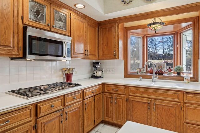 kitchen featuring sink, light tile patterned floors, stainless steel appliances, and tasteful backsplash