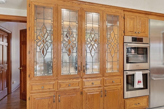 kitchen with dark hardwood / wood-style flooring and stainless steel appliances