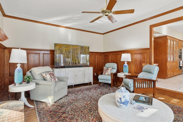 living room featuring ceiling fan, crown molding, and hardwood / wood-style flooring