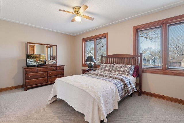 bedroom with ceiling fan and light colored carpet