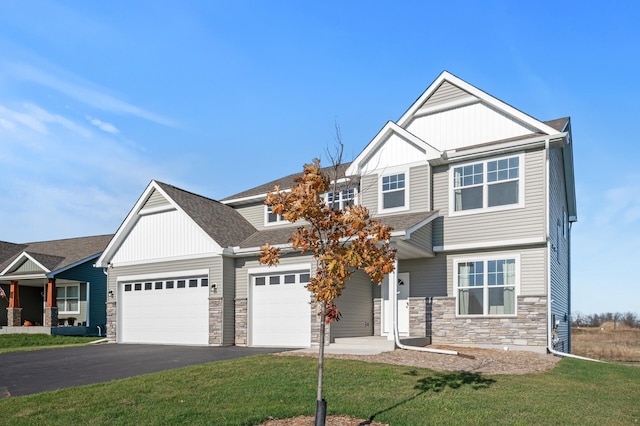 craftsman-style house featuring a front lawn and a garage