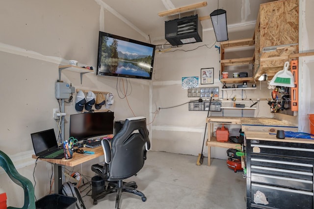 office space featuring concrete flooring and a workshop area