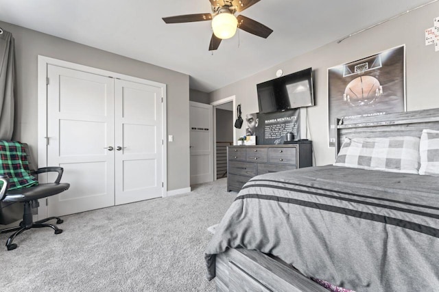 carpeted bedroom with a closet and ceiling fan