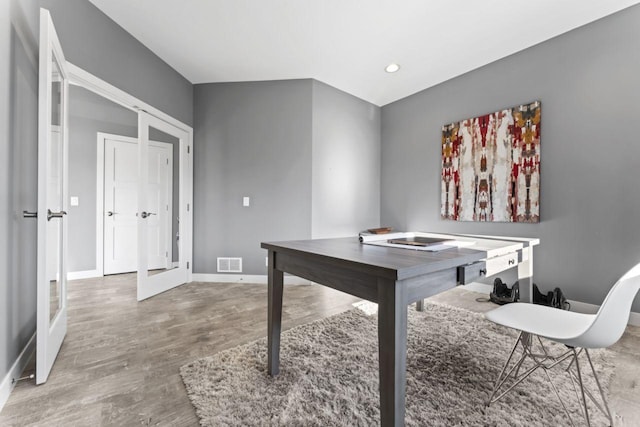 office space with french doors and hardwood / wood-style flooring