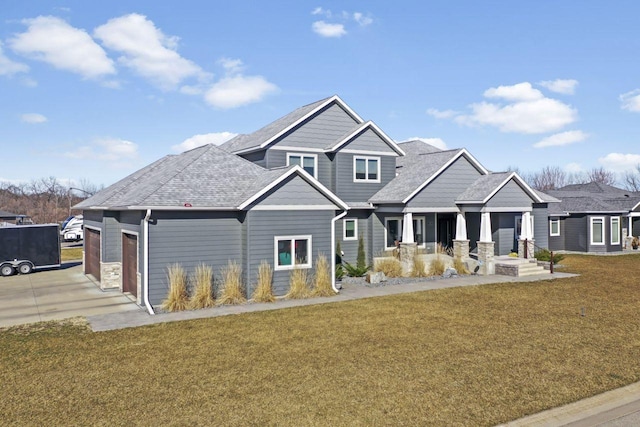 view of front of home featuring a front lawn and a garage