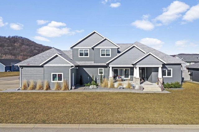 craftsman-style house with a porch and a front lawn