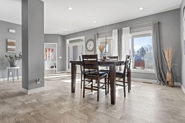 dining area featuring light wood-type flooring