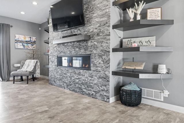 interior space with a fireplace and wood-type flooring