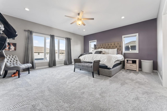 bedroom with ceiling fan and light colored carpet