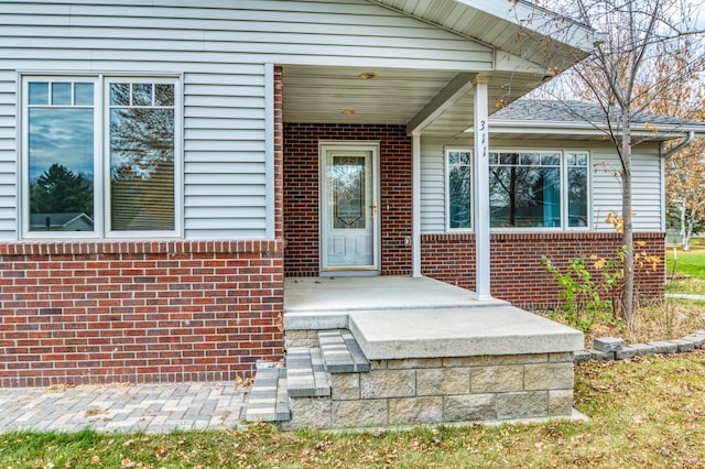 property entrance with brick siding