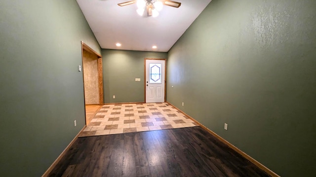 foyer entrance with ceiling fan, wood finished floors, and baseboards