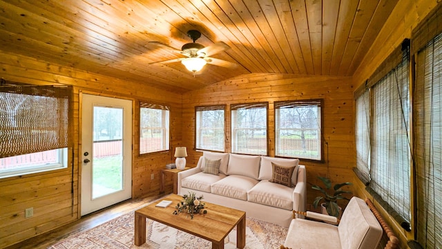 sunroom / solarium featuring lofted ceiling, a wealth of natural light, wood ceiling, and a ceiling fan