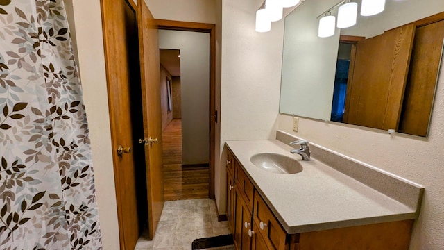 bathroom featuring curtained shower and vanity